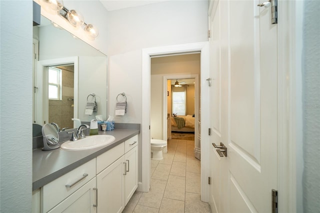 bathroom with tile patterned flooring, vanity, and toilet