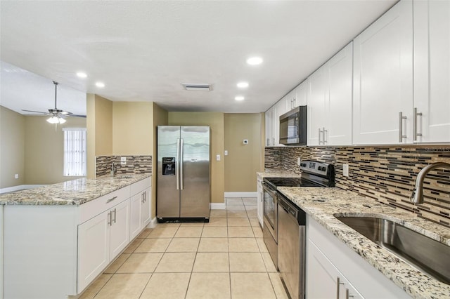 kitchen featuring stainless steel appliances, sink, and white cabinets