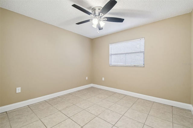 spare room featuring light tile patterned floors, a textured ceiling, and ceiling fan