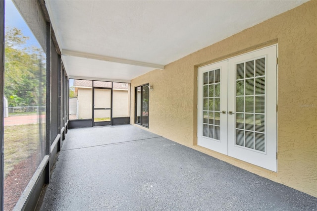 unfurnished sunroom with french doors