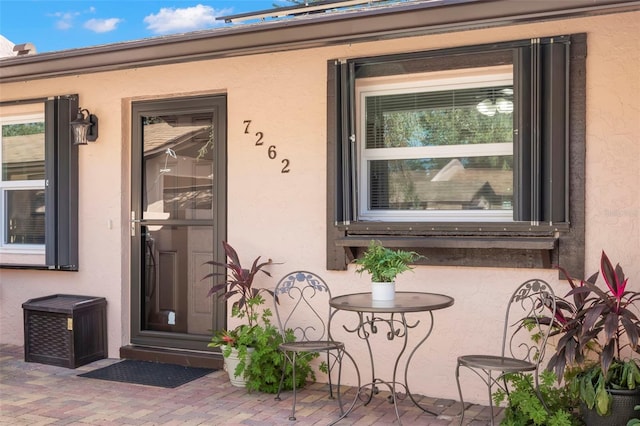 property entrance featuring a patio area