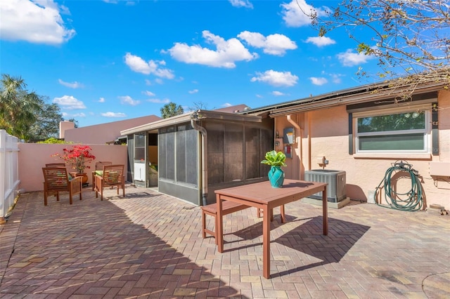 back of property featuring a sunroom, a patio, and central air condition unit