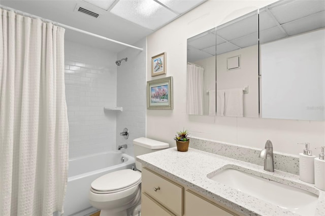 full bathroom with vanity, a paneled ceiling, shower / tub combo, and toilet