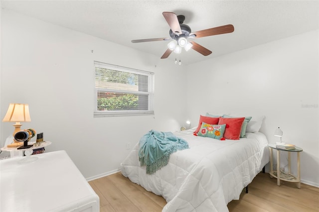 bedroom with ceiling fan and light wood-type flooring