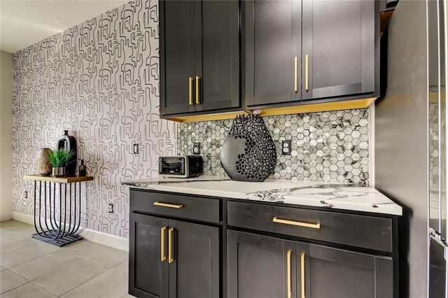 kitchen featuring light tile patterned floors, stainless steel refrigerator, and decorative backsplash