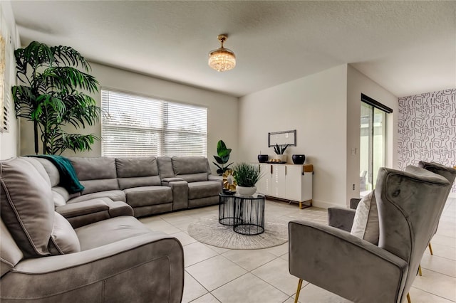 living room with a textured ceiling and light tile patterned floors