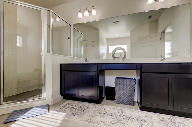 bathroom with vanity, tile patterned floors, and a shower with shower door