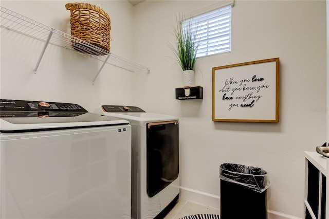 clothes washing area featuring washer and clothes dryer