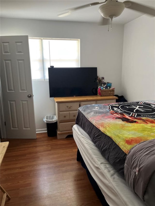 bedroom with dark wood-type flooring and ceiling fan