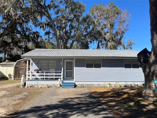 view of front facade with a porch and a shed