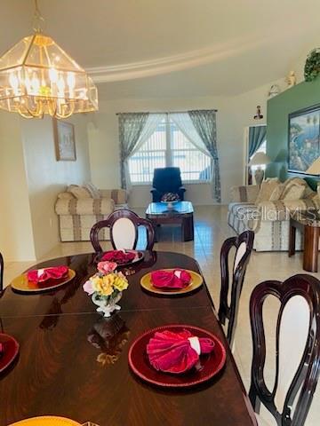 tiled dining space with a notable chandelier