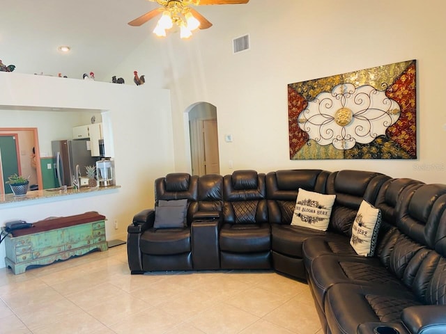 living room featuring ceiling fan, high vaulted ceiling, and light tile patterned floors