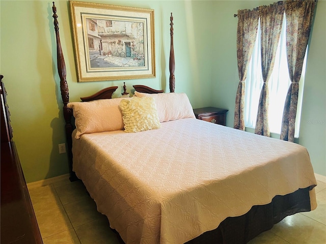 bedroom featuring baseboards and light tile patterned flooring