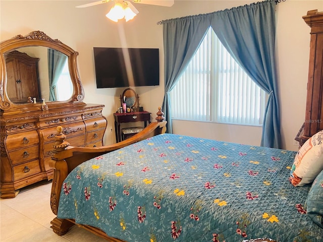 tiled bedroom featuring ceiling fan