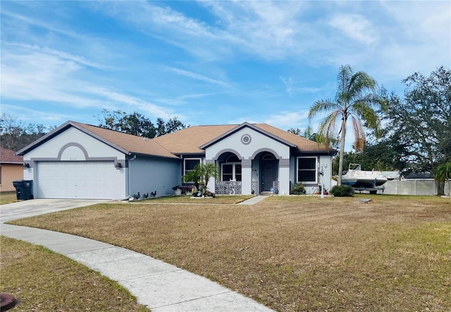 view of front of house featuring a garage, a front yard, concrete driveway, and stucco siding