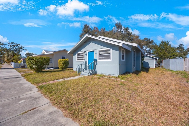 bungalow featuring a garage and a front yard