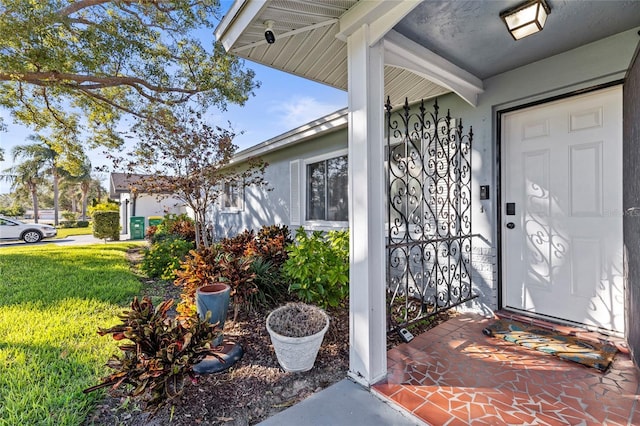 property entrance with a lawn