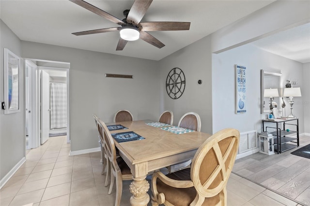 dining space with light tile patterned flooring and ceiling fan