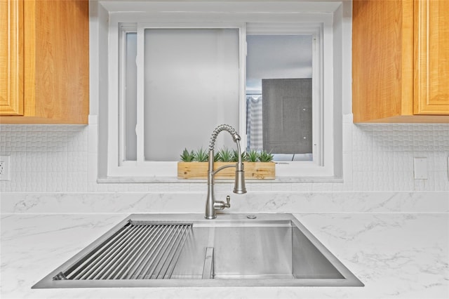 interior details featuring tasteful backsplash and sink