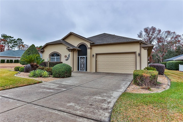 ranch-style house with a garage and a front lawn