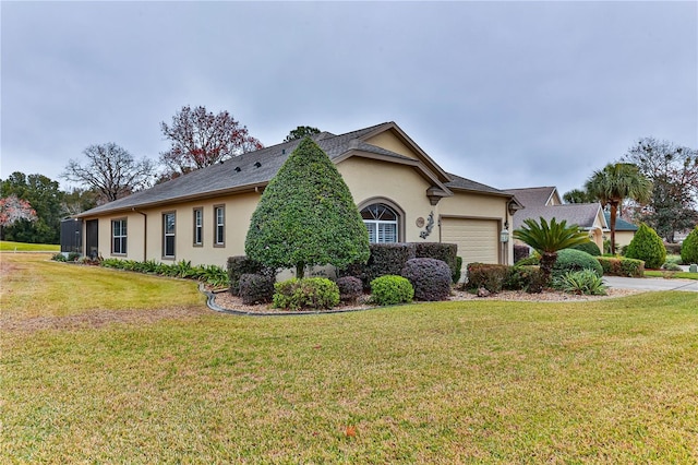 view of front of house featuring a garage and a front lawn