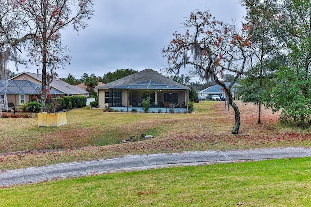 view of front of property with a sunroom and a front yard