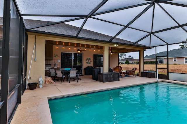 view of pool featuring ceiling fan, a patio, and glass enclosure