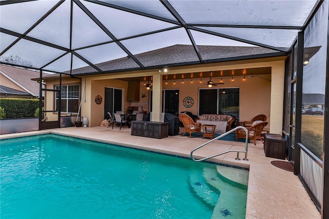 view of swimming pool with an outdoor living space, a patio, ceiling fan, and glass enclosure