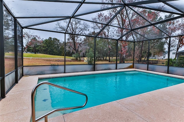 view of swimming pool featuring a patio area and glass enclosure