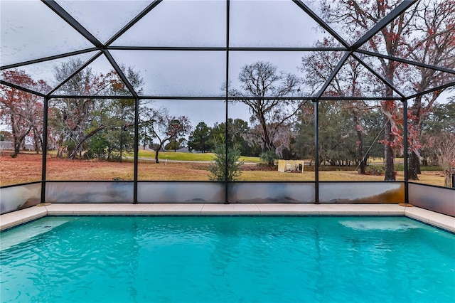 view of pool featuring glass enclosure