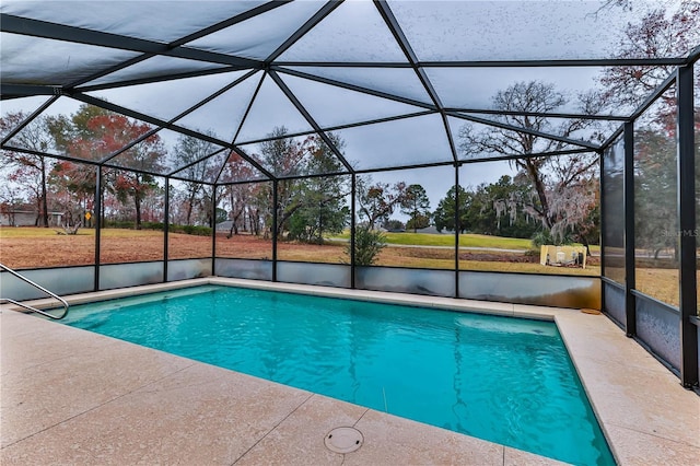 view of swimming pool with a patio and glass enclosure