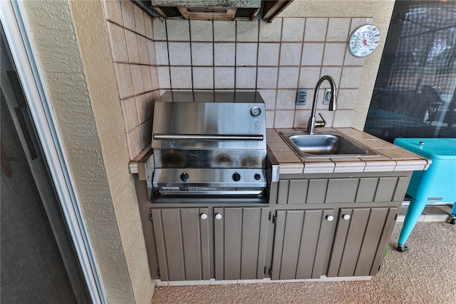 view of patio / terrace featuring a grill and sink