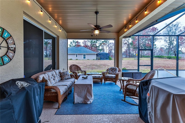 sunroom / solarium featuring ceiling fan and wooden ceiling