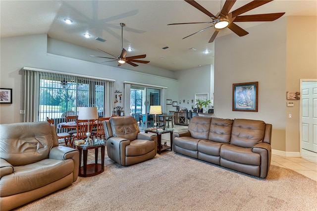 living room with vaulted ceiling, plenty of natural light, light tile patterned flooring, and ceiling fan