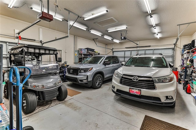 garage with a garage door opener and electric panel