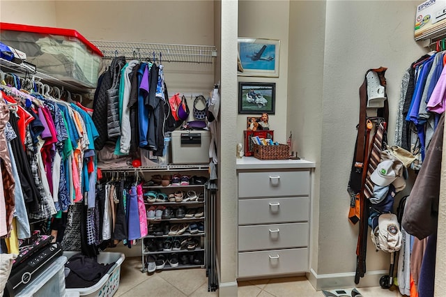 spacious closet with light tile patterned floors