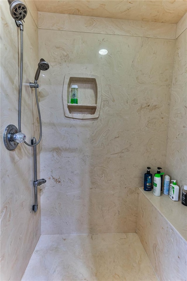 bathroom with a tile shower