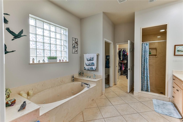 full bathroom featuring vanity, tile patterned floors, toilet, and separate shower and tub