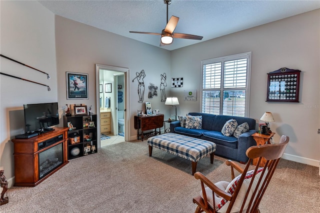 living room featuring ceiling fan, light colored carpet, and a textured ceiling