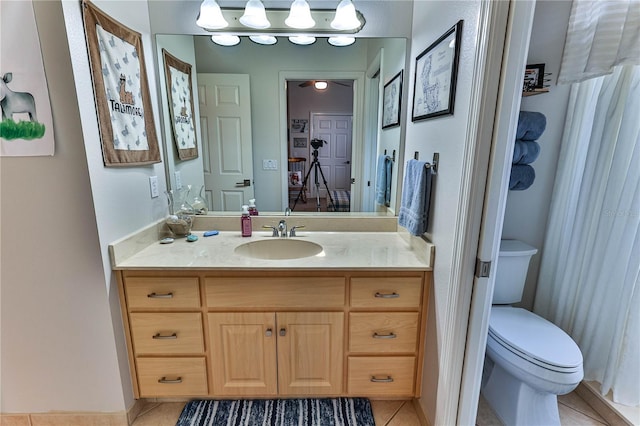 bathroom featuring tile patterned floors, toilet, and vanity