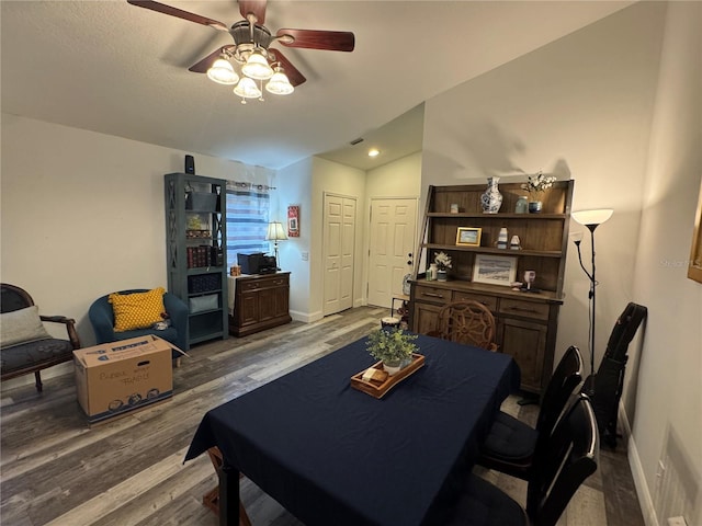 dining area with lofted ceiling, hardwood / wood-style flooring, and ceiling fan