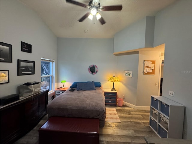 bedroom featuring high vaulted ceiling, dark hardwood / wood-style floors, and ceiling fan