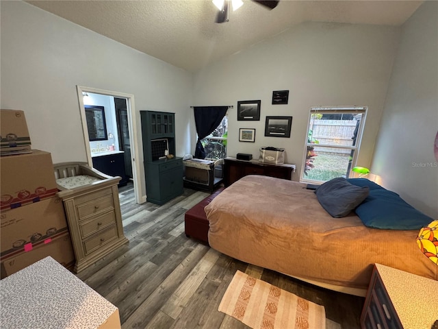 bedroom featuring high vaulted ceiling, ensuite bath, dark hardwood / wood-style flooring, ceiling fan, and a textured ceiling