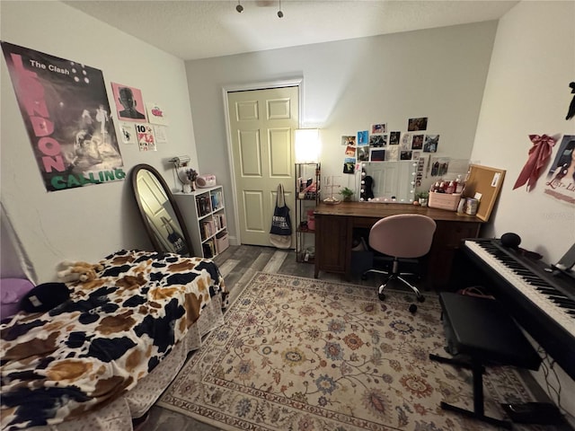 bedroom featuring hardwood / wood-style floors and a textured ceiling