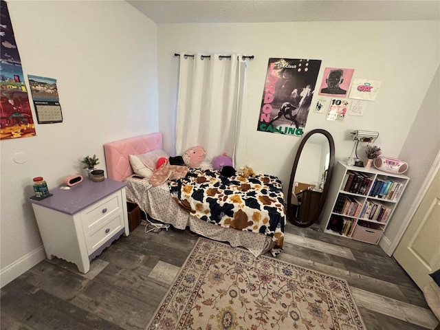 bedroom with dark hardwood / wood-style flooring