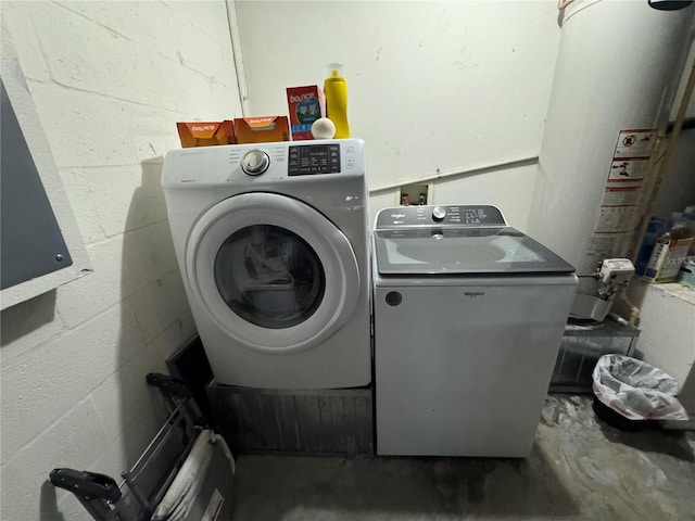 clothes washing area featuring washer and clothes dryer and gas water heater