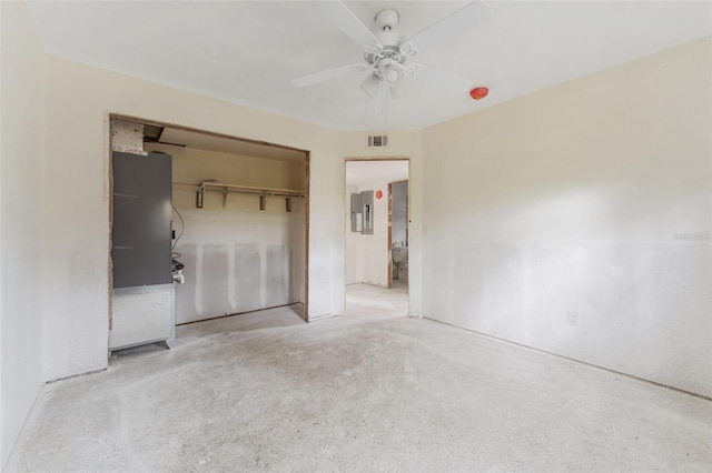 unfurnished bedroom with electric panel, a closet, and ceiling fan