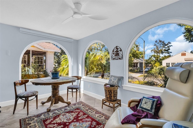 sitting room with light tile patterned floors, ceiling fan, and baseboards