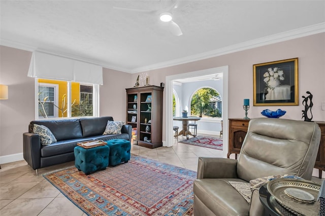 living room featuring light tile patterned flooring, ceiling fan, and ornamental molding