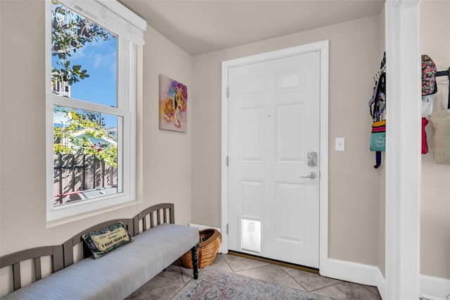 foyer entrance with light tile patterned floors